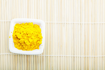 Image showing Saffron spice in white dish on mat