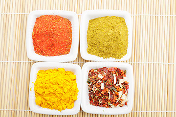 Image showing Choice of spices on mat above view