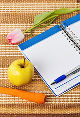 Image showing Open notebook, yellow apple and pencil 