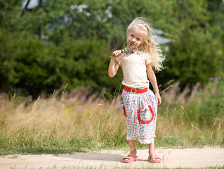 Image showing girl with wild flowers