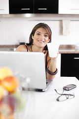 Image showing Modern woman reading e-mails at her breakfast