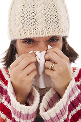 Image showing woman sneezing to a tissue