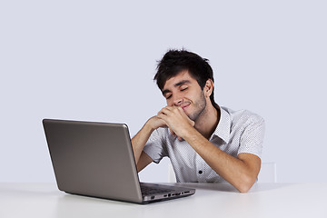 Image showing Young man dreaming in front of his laptop