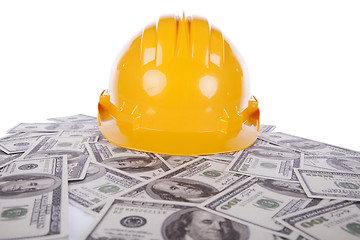 Image showing Construction helmet over a lot of money