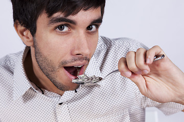 Image showing Man eating little dollar banknote