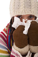 Image showing woman sneezing to a tissue