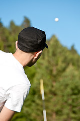 Image showing Golfer watching his ball in the air