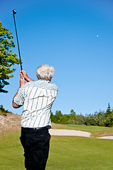 Image showing Golfer watching his ball in the air