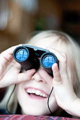 Image showing Young girl looking trought binoculars