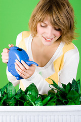 Image showing girl watering flowers