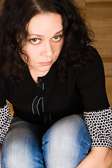 Image showing woman sitting on a wooden floor