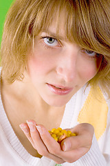 Image showing woman with heap of yellow pills