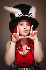 Image showing Attractive Red Haired Woman Wearing Bunny Ear Hat Framing Face