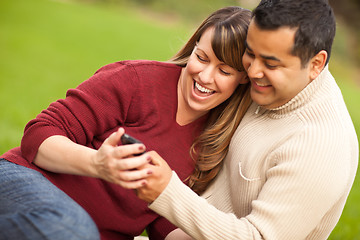 Image showing Attractive Mixed Race Couple Enjoying Their Camera Phone