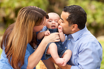 Image showing Happy Mixed Race Parents Playing with Their Son