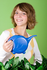 Image showing girl watering flowers