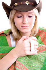 Image showing girl in a cowboy hat with cup of tea