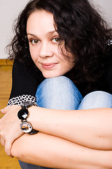 Image showing brunet woman sitting on a wooden floor