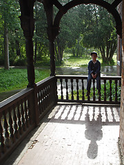 Image showing Boy and his shadow at sunny rainy day