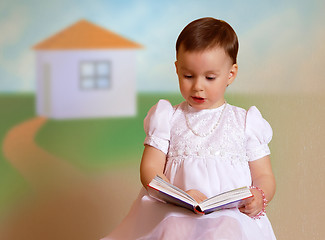 Image showing Girl reading in a white dress