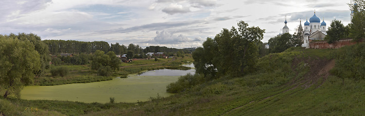 Image showing Summer around blue and white monastery.