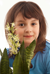 Image showing Smiling girl with blossom flower.