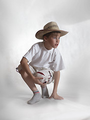 Image showing Sitting boy straw hat