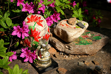 Image showing Buddha image sitting on painted rocks
