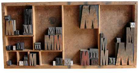 Image showing letterpress M in wood and metal in a type case