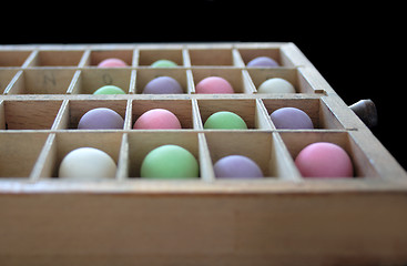 Image showing pastel balls in a type case