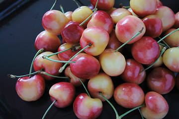 Image showing Rainier cherries on black