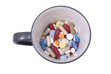 Image showing cup of multicolored tablets and capsules