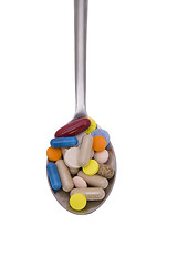 Image showing Teaspoon with pills and capsules