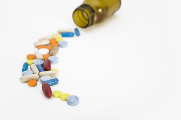 Image showing colorful stream of pills coming from a pill bottle