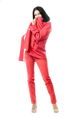 Image showing Playful brunette in red suit. Isolated