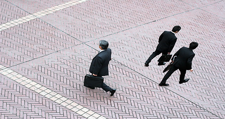 Image showing Three business men walking