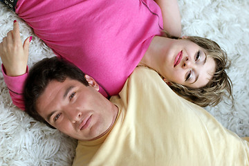 Image showing Sweet young couple lying on the rug