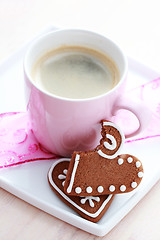 Image showing cup of coffee with cookie