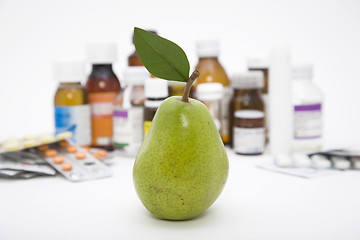 Image showing green pear in front of pills