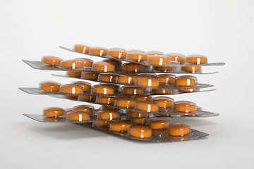 Image showing Packs of orange pills