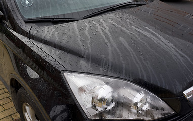 Image showing Black car with rain drops