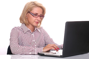 Image showing young business woman using laptop at work desk 