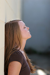 Image showing girl leaning against wall