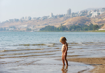 Image showing Child on the shore of lake Kinneret in the morning