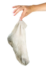 Image showing Hand holding dirty white sock