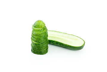 Image showing Half of cucumber and pile of slices