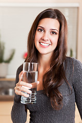 Image showing Woman holding glass of water