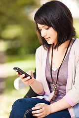 Image showing Mixed race student texting