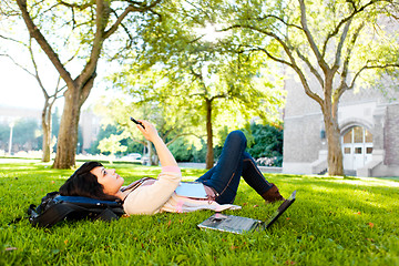 Image showing Mixed race student texting