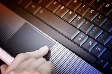 Image showing Working at laptop .